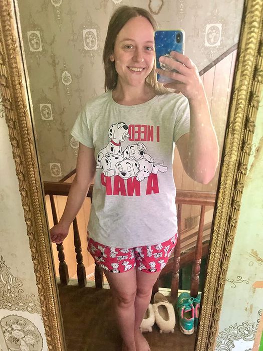 a reviewer sporting a gray t-shirt adorned with Dalmatian puppies and a catchy saying