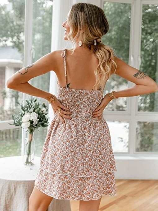 A model showing the back view of the dress.
