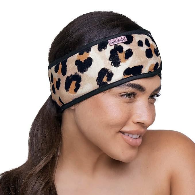 A model wearing a leopard print version of the makeup headband.