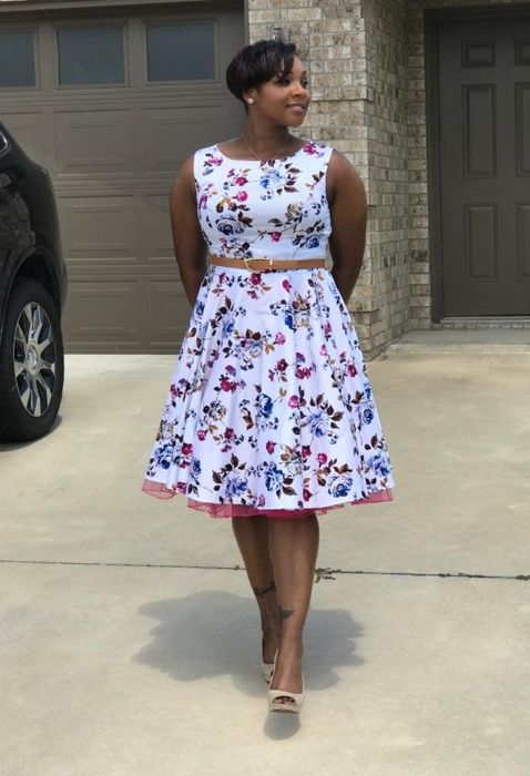 The same reviewer rocking a white and purple floral version of the dress.