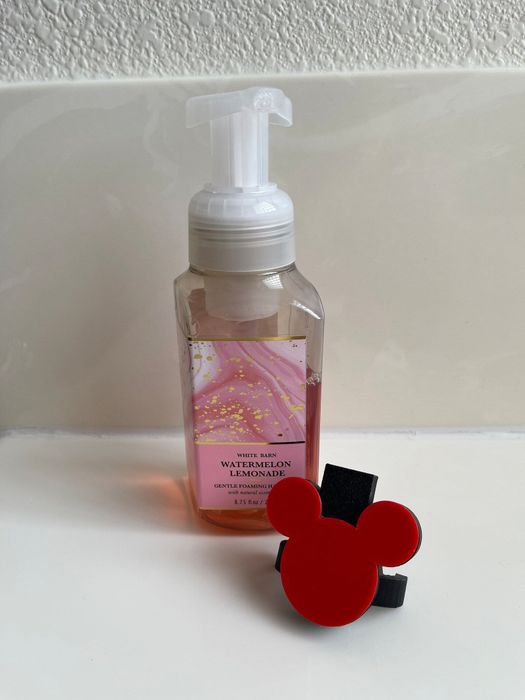 A bottle of foaming hand soap with a Mickey-themed label.