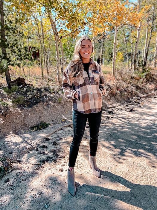 A reviewer wearing the shacket in brown.