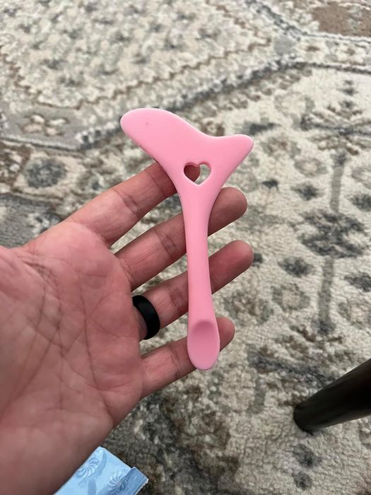A reviewer holding the eyeliner stencil tool.