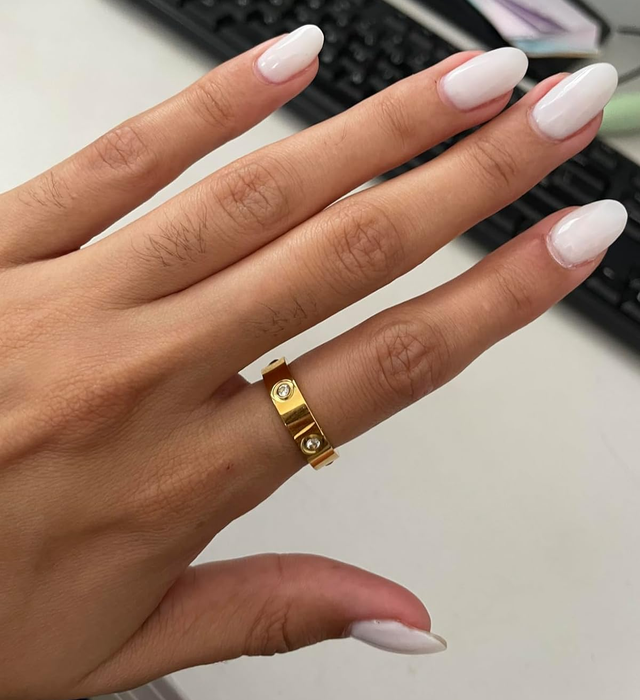 A reviewer showcasing the gold ring on their hand