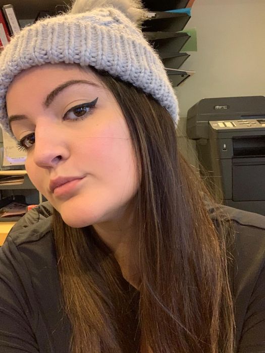 The reviewer showcasing their perfect cat-eye after using the stamp.