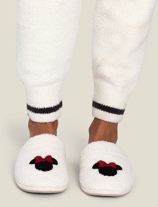 white fluffy slippers adorned with a Minnie Mouse icon