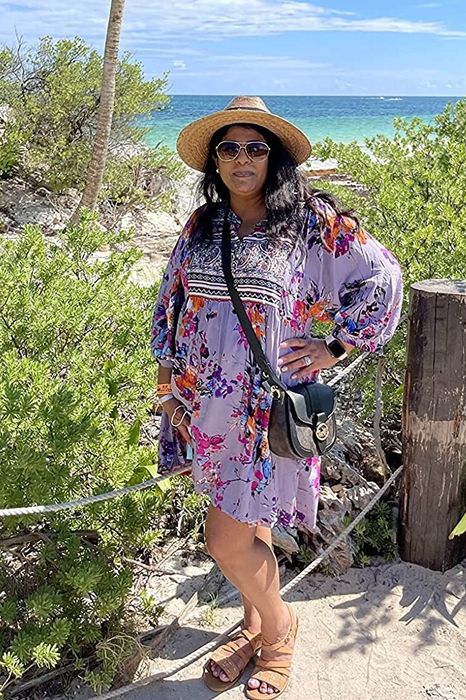 Reviewer wearing the tunic dress in a soft light purple shade.