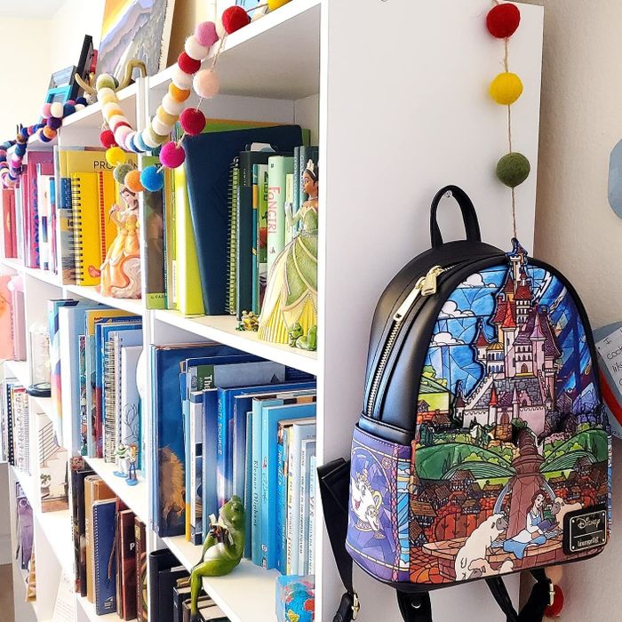 A photo of a reviewer’s Beauty and the Beast Loungefly backpack hanging off their shelf, capturing the intricate design.