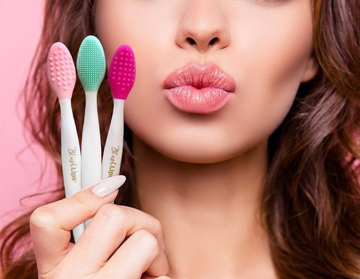 A model showcasing three scrubber lip brushes.