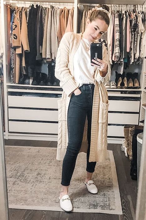A reviewer modeling the white loafer mules