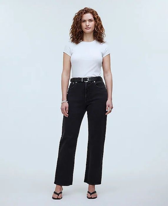A model showcasing sleek black straight-leg jeans, adding a touch of sophistication to any casual look.