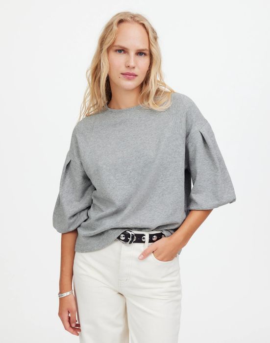 A model showcasing the gray version of the top.