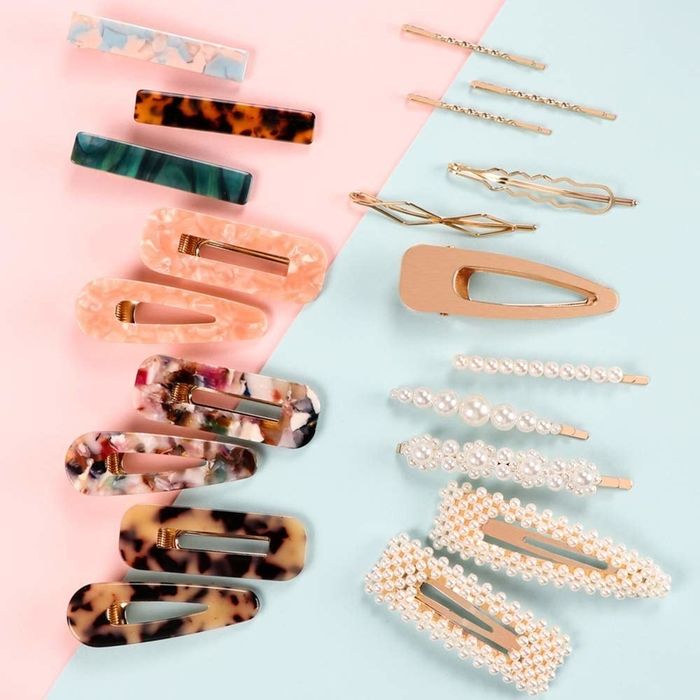 Colorful tortoise shell, dark blue, and marble-patterned hair clips neatly arranged in lines