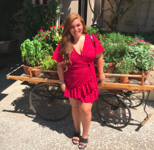 A customer review photo displaying the V-neck dress in red.