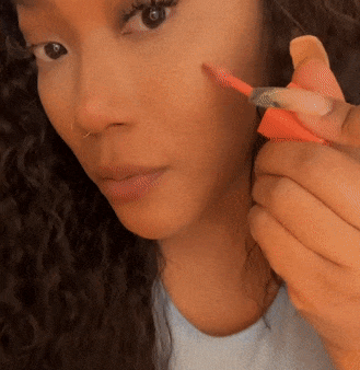 A gif showing me applying the blush oil to my cheek.