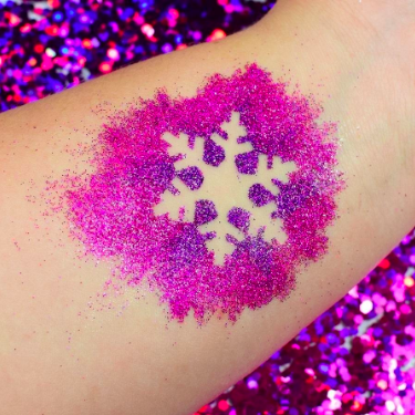 Glittery eyeshadow swatched on the forearm, demonstrating the primer's impact.