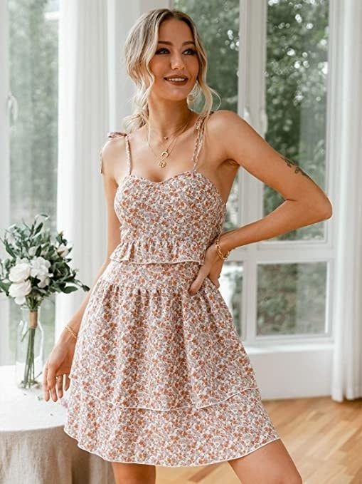 A model in the light pink strappy flare dress.