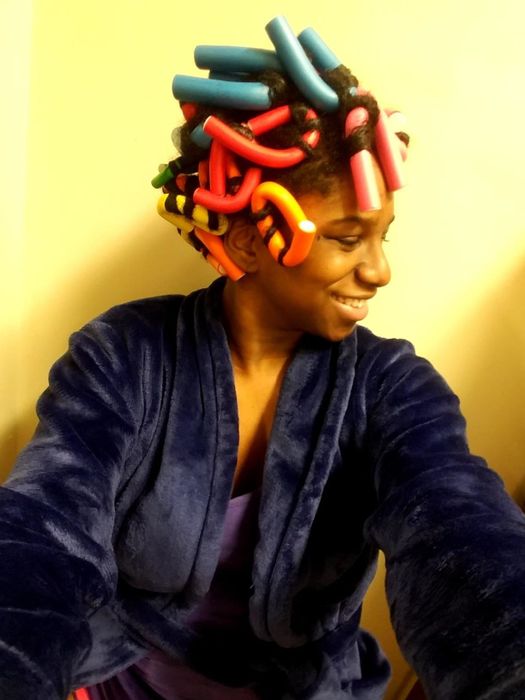 Reviewer uses pink and blue curling rods in their hair