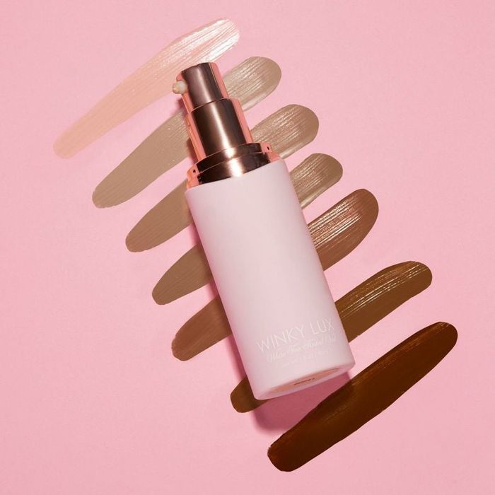 image of the product with swatches of all shades displayed behind it