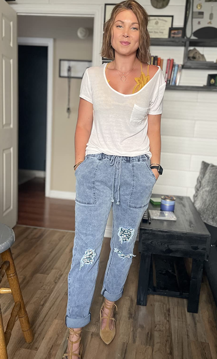 reviewer wearing the denim joggers with the cuffs at the ankles