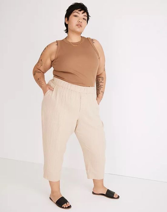 model wearing beige balloon pants paired with a brown tank top and black sandals