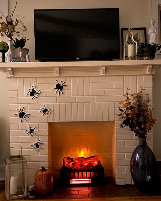 A reviewer showing off the electric logs in their fireplace, adding a cozy touch to the room.