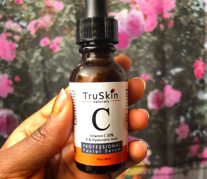 Reviewer holding a bottle of serum