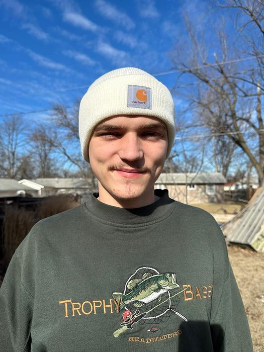 Reviewer sporting a white beanie