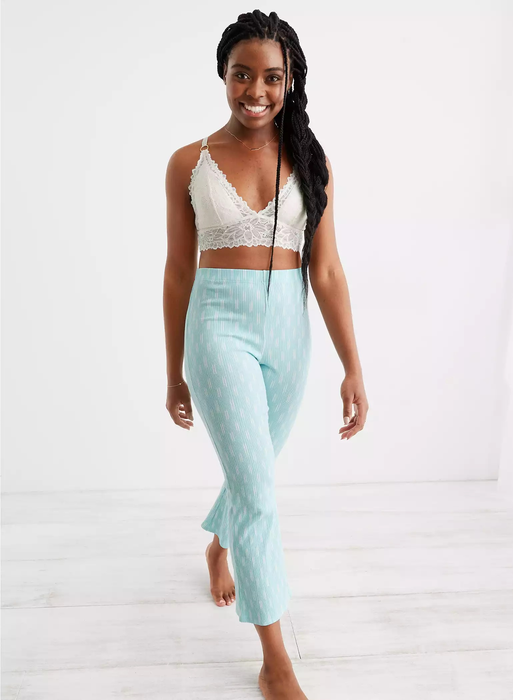 model in light blue leggings paired with a white crop top
