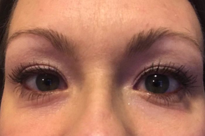 A reviewer wearing the mascara, displaying the dramatic effect it has on her lashes.