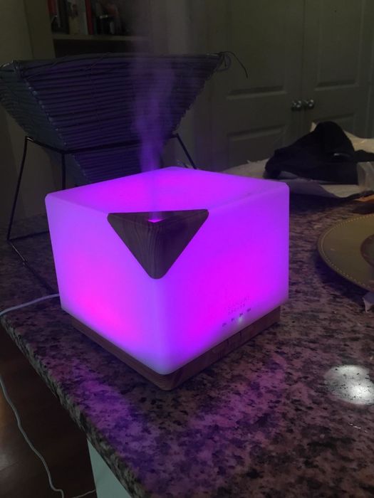 A reviewer's diffuser placed on the kitchen table, creating a peaceful environment.