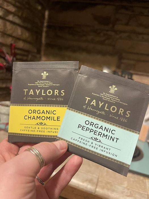 A reviewer is pictured holding the Organic Chamomile and Organic Peppermint tea packets.