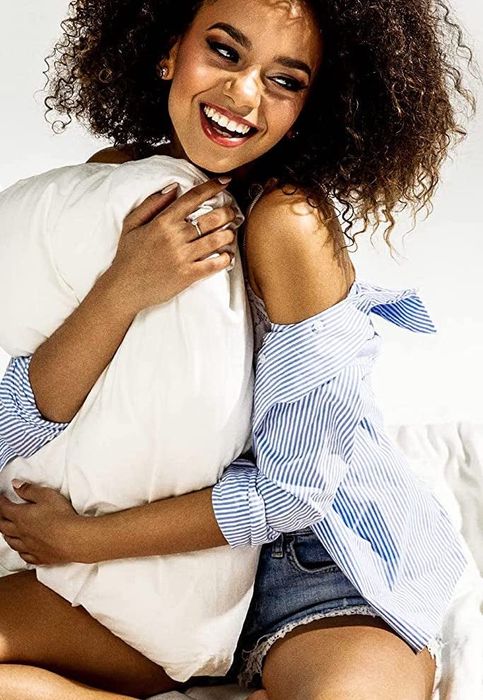 model giving one of the pillows a gentle squeeze