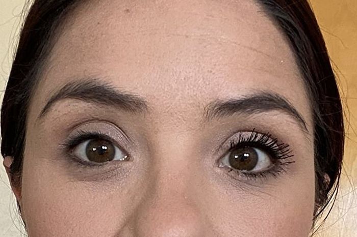 The reviewer wearing mascara on just one eye for a comparison shot