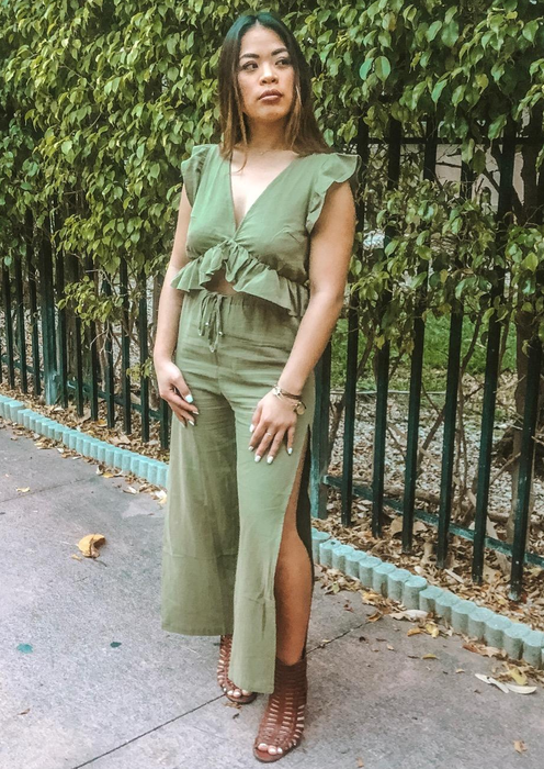 reviewer styled in the green top and pants