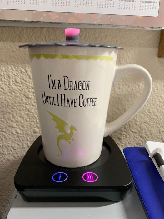mug placed on a black mug warmer with the settings displayed