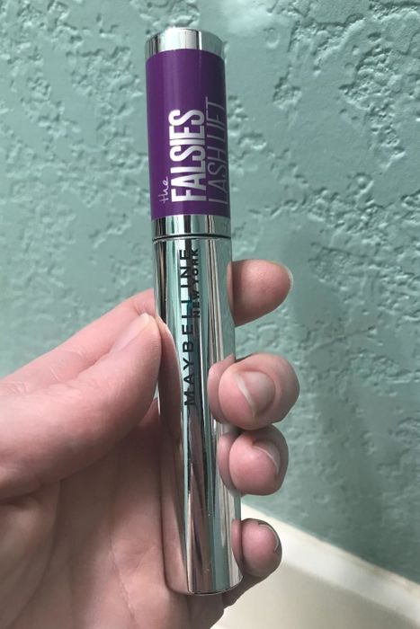 A reviewer displaying the mascara.