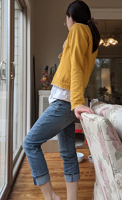 side view of a reviewer in cropped jeans with a yellow long sleeve top