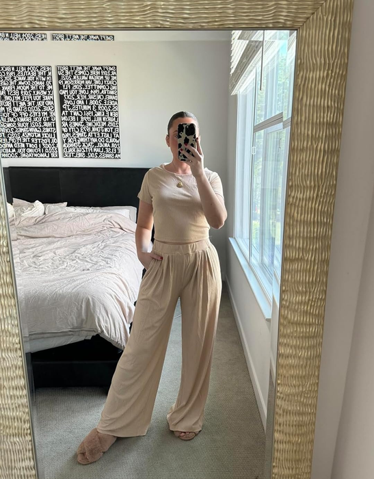 A reviewer lounging in the beige two-piece set, enjoying comfort and style all at once.