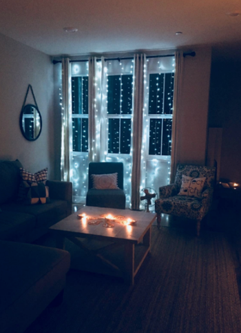A picture showing the string lights draped over windows.