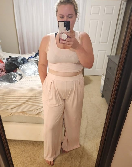 A reviewer wearing the light pink lounge set, looking cozy and comfortable.
