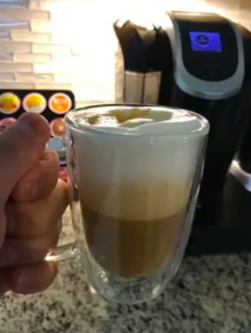 Reviewer's cup filled with frothy coffee