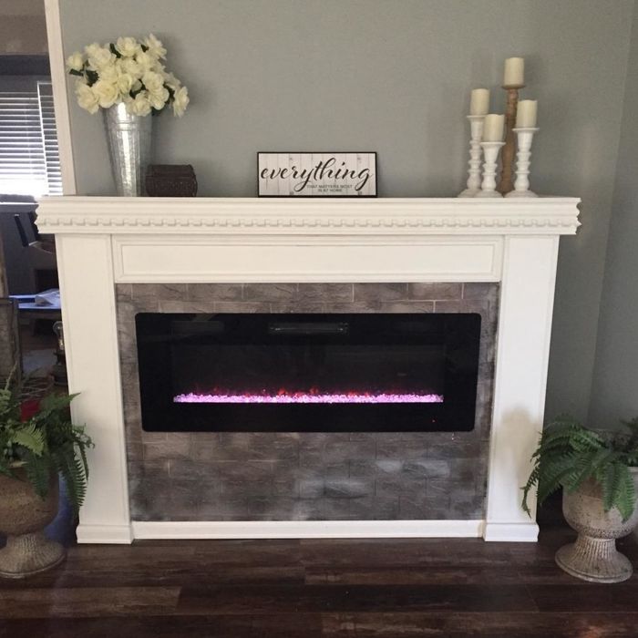 A reviewer's electric fireplace neatly installed within a mantel, creating a cozy focal point in the room.