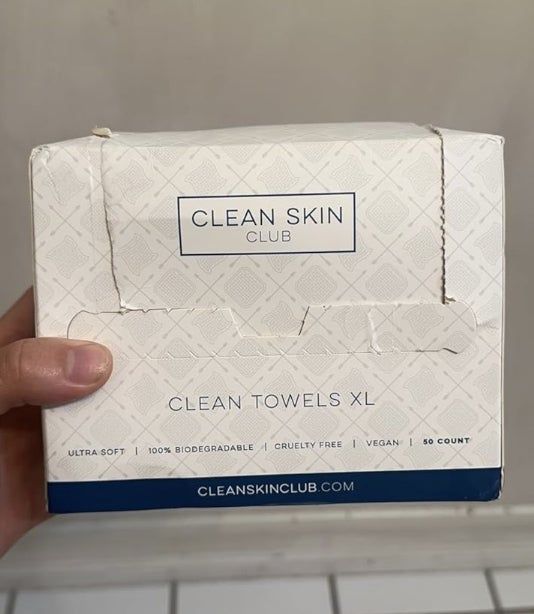 A hand holding a box.