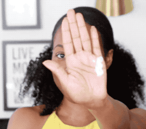 Model applying the sunscreen and showing how it leaves no white cast behind