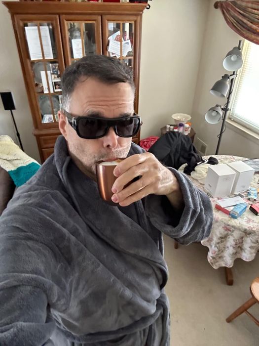 Reviewer in a grey robe with a waist tie