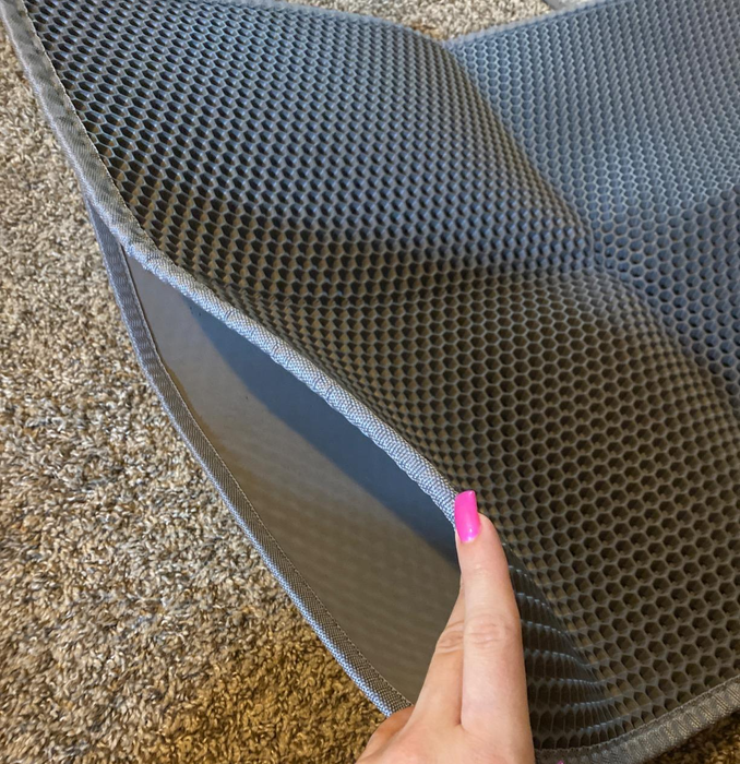 a reviewer holding the mat open to reveal its interior design