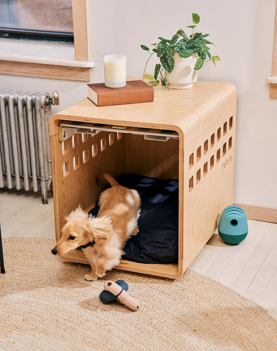 A wooden crate adorned with plants and books placed on its surface.