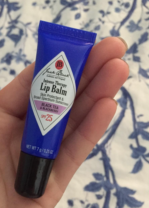 A reviewer image showing someone holding a tube of blackberry lip balm