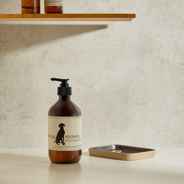 The animal wash bottle placed beside a soap dish.
